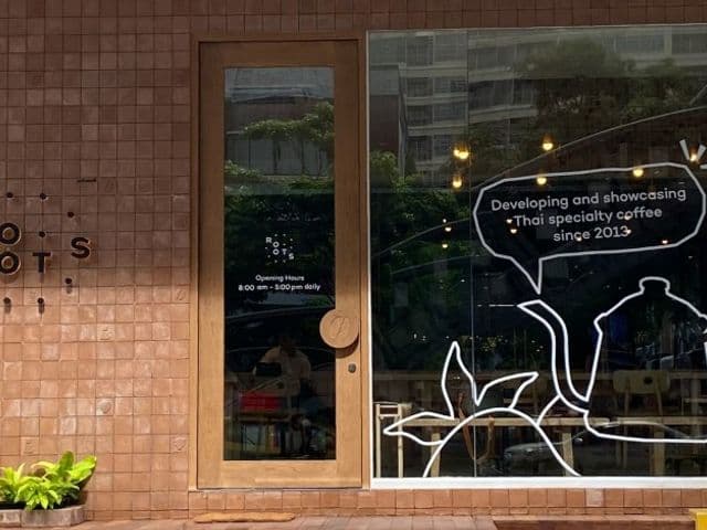Rootsのテラコッタタイルの外観、木製ドアと2013年からのタイ産スペシャルティコーヒーを伝える窓のイラスト